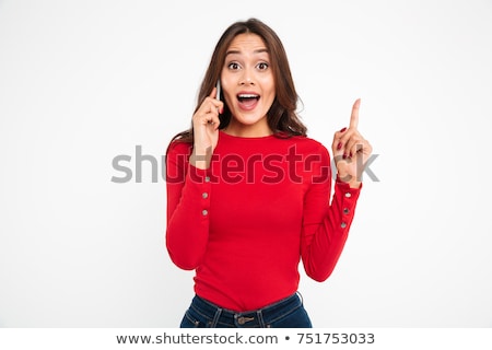 Stockfoto: Smiling Casual Woman Talking On The Phone Is Pointing Finger