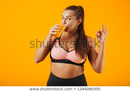 Zdjęcia stock: Image Of Pretty Chubby Woman In Tracksuit Smiling And Drinking O