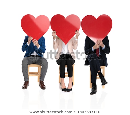 Foto stock: 3 People Covering Their Faces With Big Red Hearts