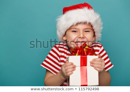 Stok fotoğraf: Happy Boy In Santa Hat With Gift Box On Christmas