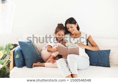 Stockfoto: Portrait Of Mother And Daughter Reading Book