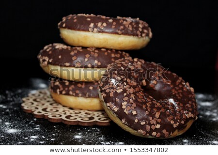 ストックフォト: Chocolate Donut In A Womans Hand On Black Background