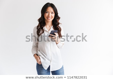 Stok fotoğraf: Photo Of Joyful Asian Woman With Long Dark Hair Holding And Spea