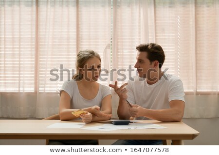 Zdjęcia stock: Financial Advisor Sitting With Depressed Couple