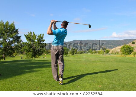 Foto stock: Young Male Golfer Playing Off The Tee Box