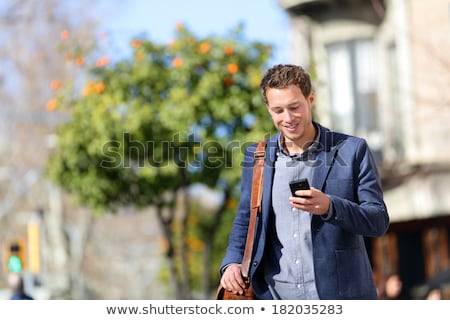 ストックフォト: Young Man With Cell Phone Walking