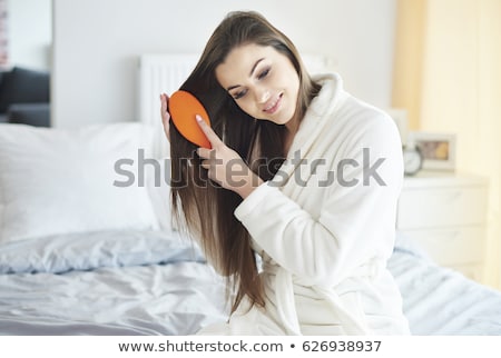 Stockfoto: Beautiful Woman Brushing Her Hair At Home