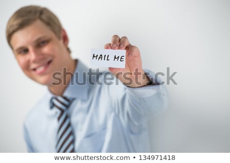 商業照片: Handsome Businessman Showing Call Me Text On A Business Card