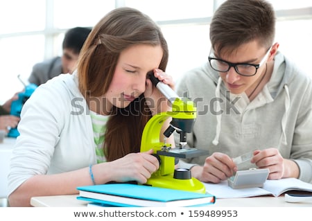 Foto stock: High School Students Beautiful Girl Working At Biology Classroo