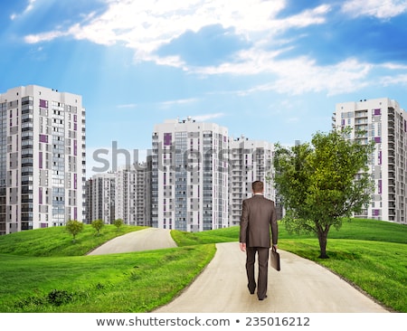 Businessman Walks On Road Rear View Buildings Grass Field And Sky With Virtual Elements Stockfoto © cherezoff