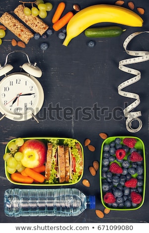 Stockfoto: Health Fitness Food In Lunch Boxes Measuring Tape And Alarm