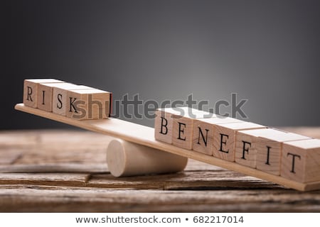 Foto stock: Wooden Block With Risk And Benefit Wooden Block On Seesaw