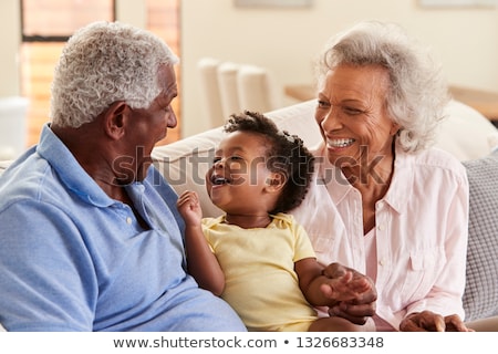 Foto stock: Front View Of African American Grandfather And Granddaughter Placing Picnic Blanket In The Backyard