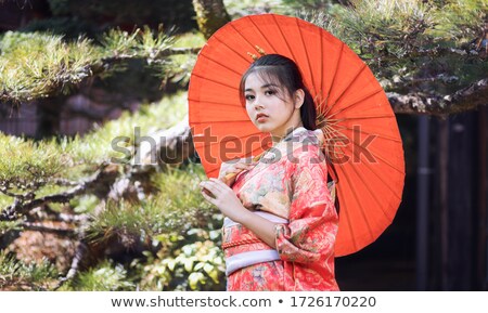 Сток-фото: Image Of Young Geisha Woman In Japanese Kimono Holding Wooden Ha