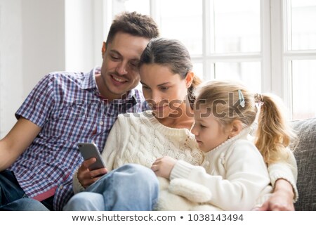 Zdjęcia stock: Three People Looking At Mobile Telephone Screen