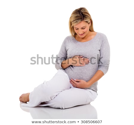 Stockfoto: Studio Portrait Of A Beautiful Young Pregnant Woman Isolated On Red Background