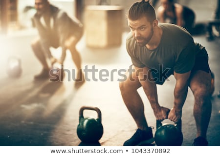 Foto stock: Male Athlete Exercising With Dumbbells