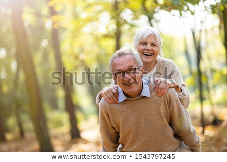 ストックフォト: Mature Man Giving Piggyback To His Wife