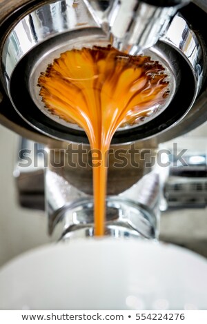 Stockfoto: Espresso Machine Pouring Coffee Into A White Cup