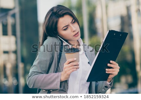 Stok fotoğraf: Young Serious Businesswoman In Formalwear Listening To Speaker