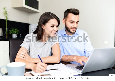 Foto d'archivio: Couple Filling Tax Return Form