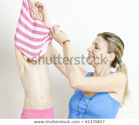 Stockfoto: Mother With Her Daughter During Changing The Clothes