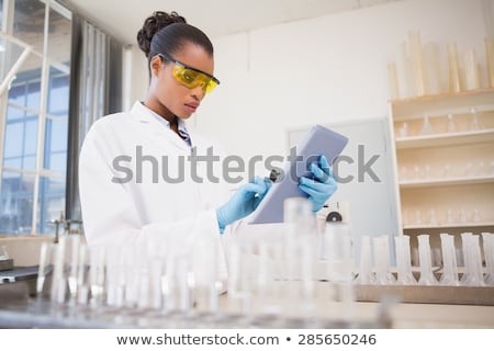 Foto stock: Chemical Scientist Using Digital Tablet Computer