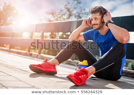Stock fotó: Handsome Young Man Listening To Music After Running