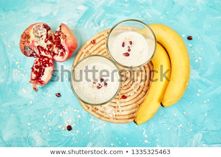 Stockfoto: Smoothie With Oat Or Oatmeal Banana And Pomegranate On Blue Background