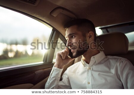 Сток-фото: Businessman Sitting Inside Car Talking On Cellphone