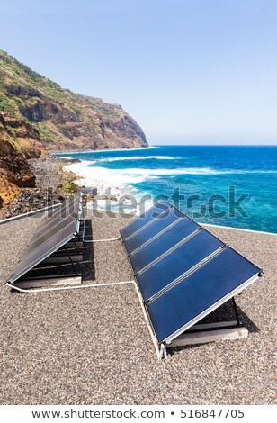 Stock fotó: Rows Of Solar Collectors On Roof At Beach And Sea