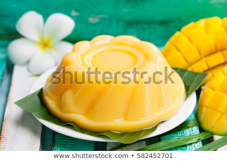 Stockfoto: Mango Pudding Jelly On White Plate With Palm Leaf