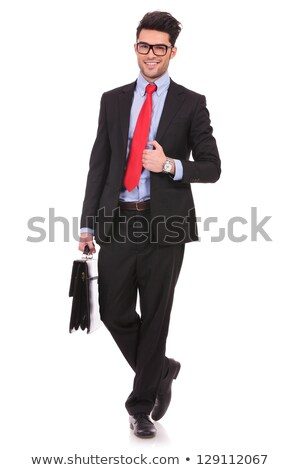 Stockfoto: Business Man Holding Briefcase Is Fixing His Tie And Walks