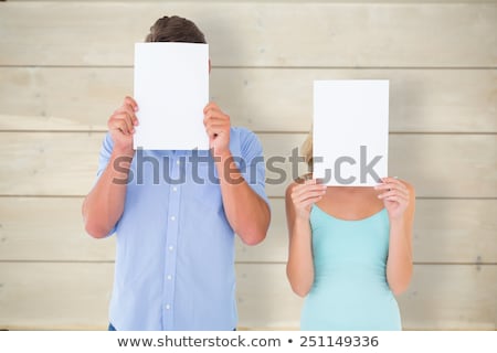Сток-фото: Young Casual Man Covering Face With Blank Board