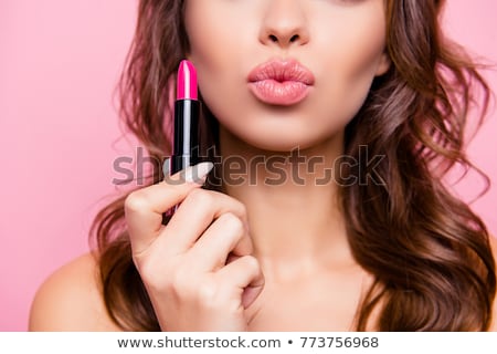 Foto d'archivio: Beautiful Model Girl Holding Lipstick Tube Makeup