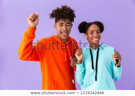 Zdjęcia stock: Photo Of African American Couple In Colorful Clothes Singing Whi