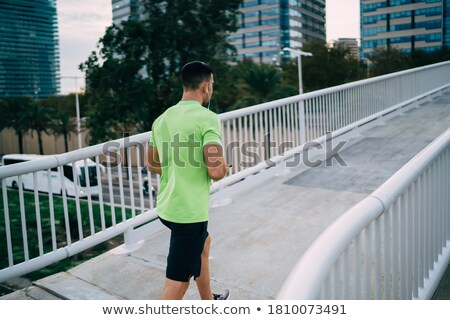 Stok fotoğraf: Anonymous Sportsman Using Phone