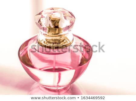 Foto d'archivio: Pink Perfume Bottle On Glossy Background Sweet Floral Scent Gl