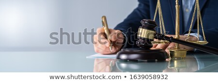 Foto stock: Male Judge Signing Document At Desk