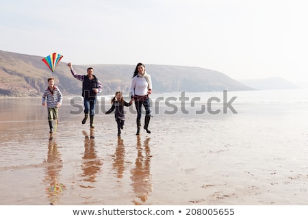 Stock fotó: Family Having Fun On Winter Beach