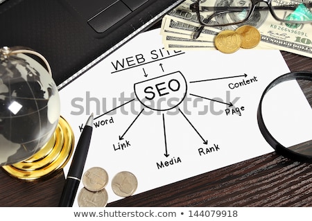Foto d'archivio: Workplace With Seo Sheme On Paper And Money