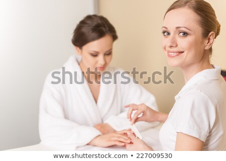 Foto d'archivio: Manicurist Cleaning A Customers Nails