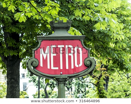 Сток-фото: Parisian Metro Sign With A Lamppost Against Vintage Wall