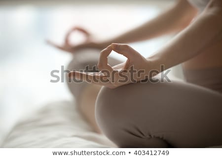 Foto stock: Female In Yoga Pose Sitting On Bed