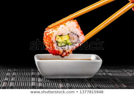 Foto stock: Sushi Roll Dipped In Soy Sauce