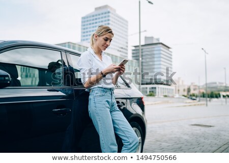 Foto stock: Sms Mobile Phone Woman By Car