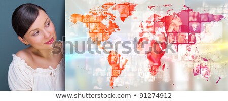 [[stock_photo]]: Portrait Of Young Woman Standing In Fron Of Big World Map And Lo