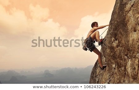 Stock foto: Rock Climber On Sunset Background