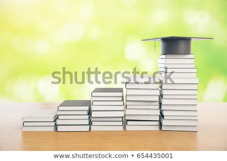 Foto stock: Graduation Mortarboard On Top Of Stack Of Books On A Wooden Tabl
