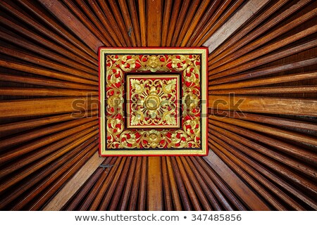 Foto stock: Beautiful Symetrical Hand Carved And Painted Wooden Relief